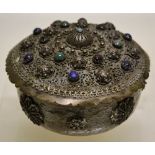 An Eastern silver coloured metal circular pot pourri jar, with a pierced cover set semi precious