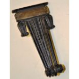 A Regency cast iron black painted door knocker, reeded tapering form with a brass plate and tulip