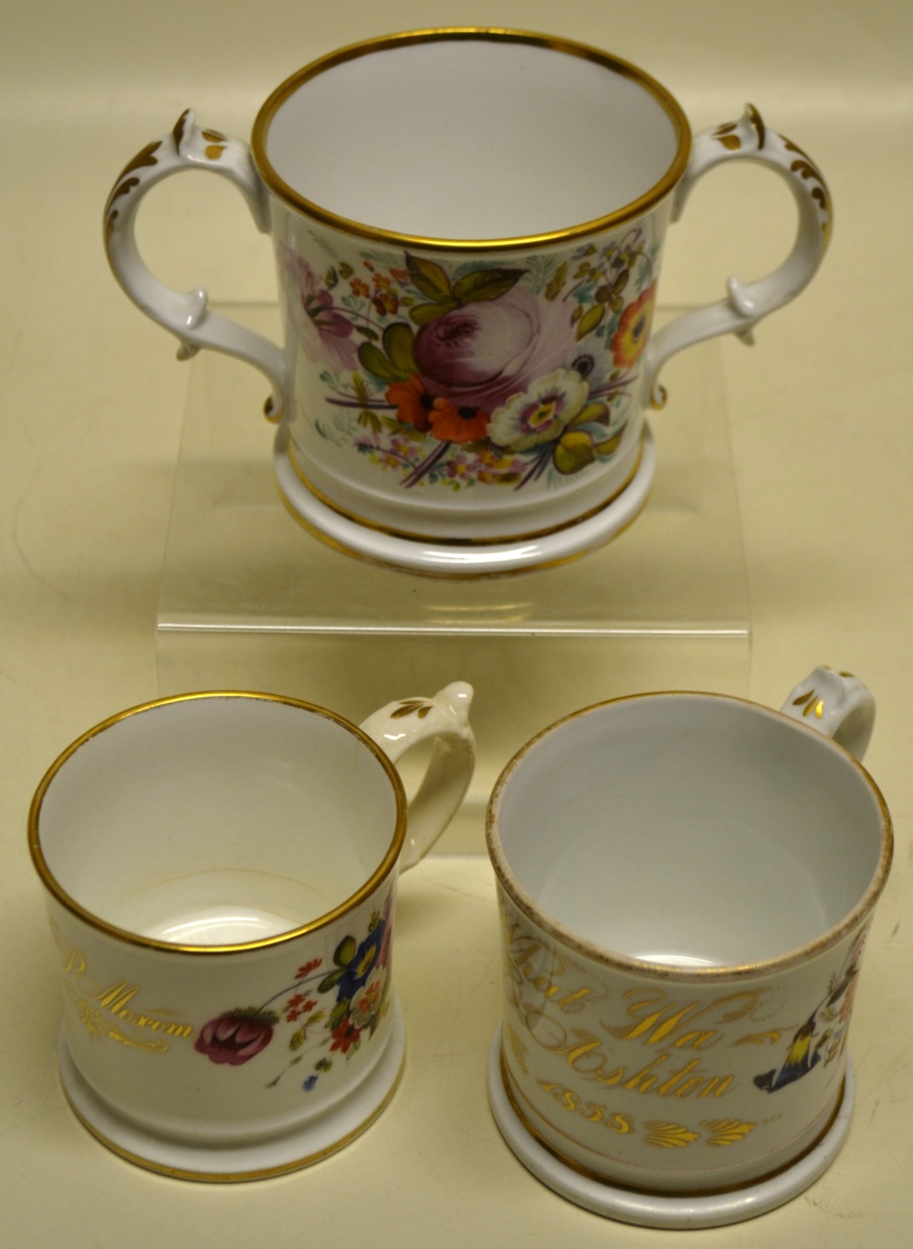 Two Victorian Coalport mugs, decorated flowers and in gilt 'Anna P. Maxon' and 'What'wa E. Ashtown,'