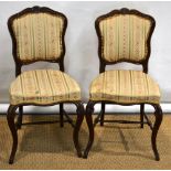 A pair of early Victorian rosewood framed bedroom chairs, with moulded padded cartouche shape backs,