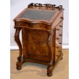 A Victorian burr walnut veneered Davenport, the top with a pierced fret gallery, a sycamore veneered