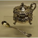 An early Victorian silver mustard pot, in the Rococo Revival style, the circular ogee body with