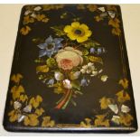 A Victorian black papier mache desk blotter, the front cover painted a posy of flowers, gilt vine