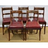 A set of five Regency mahogany side chairs with veneered crest panels to bar backs, the padded seats