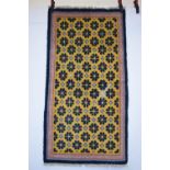 Tibetan rug with pale yellow field, first half 20th century, 4ft. 9in. x 2ft. 6in. 1.45m. x 0.76m.