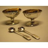 Two George III silver oval salts, gilded inside, engraved a star crest and initials, beaded borders,