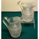 A pair of Irish early nineteenth century cut glass water jugs, with hobnail panelled sides and