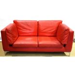A modern Italian red leather covered office box seat sofa, with cushions for the back and seat, on