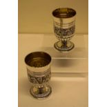 A Regency silver pair of Scottish wine goblets, the tall bowls chased with a band of grape vines,