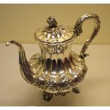 A William IV silver melon panelled coffee pot, girdled with repousse foliage, having a swan neck