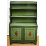 A Regency green painted pine open shelf side cabinet, the waterfall bookcase top above a cupboard,