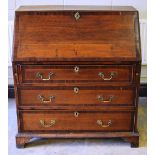A late eighteenth century oak bureau, of low proportions, the mahogany banded front with a fall