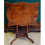 A George IV mahogany serpentine tilt top table occasional table, the block on four ring turned