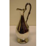 A Victorian silver wine jug, the plain vase shape body with a cast grapevine branch handle, on a