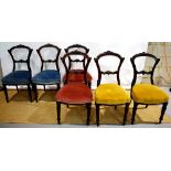 A set of six Victorian walnut side chairs, the shaped open backs with carved florettes and laurel to