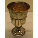 A George IV silver wine goblet, the tapering bowl partly ribbed with a chased repousse border of