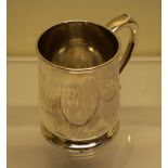An early George II silver mug, the side engraved initials, having a capped scroll handle, the tuck