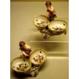 A pair of Berlin nineteenth century porcelain double salts, the oval bowls painted with pheasants