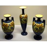 A garniture of three late Victorian Royal Staffordshire pottery vases, in Grecian Revival style, the