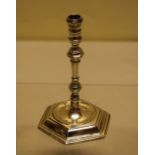 A George I style cast silver taperstick, the spool turned holder on a knopped hexagonal stem to a