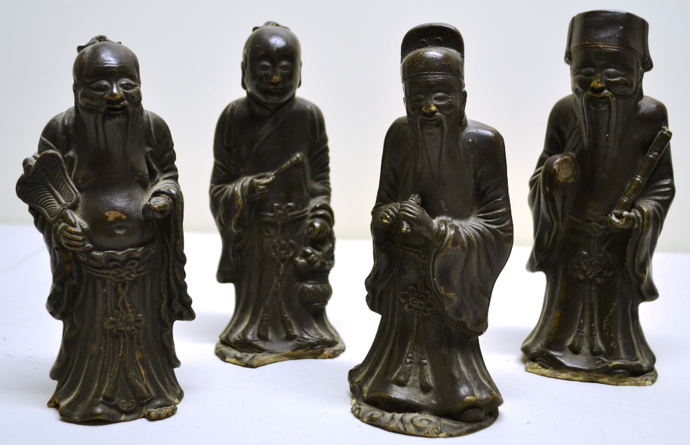 Four Chinese cafe au lait figures of immortals (slight damage) probably eighteenth century.