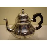 An early Victorian silver teapot, in early eighteenth century Hausemalder style, with flat chased