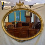 A nineteenth century oval gilt frame mirror, in Adam Revival style, the bevelled glass with an egg