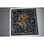 Two Chinese woven panels, 19th century, the first embroidered a dragon in gold coloured metal