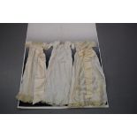 Three christening gowns, two fine lawn with pin tucks and lace inserts with satin ribbon sashes; the