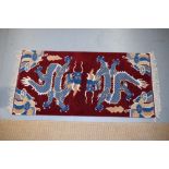 Pair of pictorial Tibetan rugs each depicting a pair of confronting dragons among clouds, north