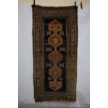 Kurdish long rug, north west Persia, circa 1920s,. 7ft. 8in. X 3ft. 8in. 2.34m. X 1.12m. Some wear