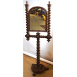 An early Victorian mahogany shaving stand, the domed swing mirror, on spiral twist supports with