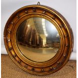 A mid nineteenth century convex mirror, in a gilt ball decorated frame. 23in (59cm) diameter.