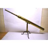 A nineteenth century brass library telescope, on a stand with three folding iron cabriole legs.