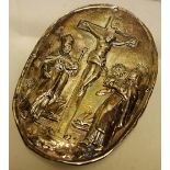 A German silver oval religious badge, repousse scene of the crucifixion, with Mary Magdalene and a