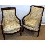 A matched pair of French early nineteenth century mahogany frame fauteuils, upholstered cream ground