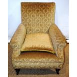 A late Victorian easy armchair, upholstered in yellow figured material, on front turned walnut