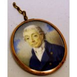 A Regency portrait oval miniature on ivory, of a gentleman wearing a blue coat in a gold frame.