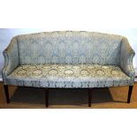 A Hepplewhite settee, upholstered in steel blue damask, having a shaped crested back and arms to a