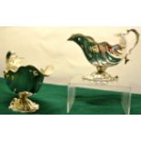 A pair of George II silver cast rococo sauceboats, the fluted bodies with a shaped gadroon border,