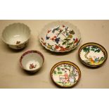 A Chinese Kang Hsi porcelain tea bowl and saucer, the sides fluted, decorated in coloured enamels, a