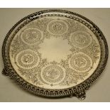 A Victorian silver salver, engraved a circlet of panels of grapes and flowers linked by foliage