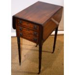 A Regency mahogany work table, the drop leaf top crossbanded in tulipwood, the frieze inlaid ebony