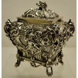 A George IV Scottish silver Chinoserie Revival rectangular tea caddy, the repousse sides with