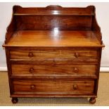 A William IV faded mahogany dressing table chest, the top with a raised shelf back and downswept