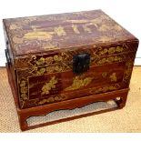 A nineteenth century Chinese red lacquer rectangular trunk, with gilt decoration of noblewomen and