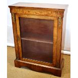 A nineteenth century pier cabinet, veneered in figured walnut, the frieze inlaid floral marquetry