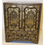 A nineteenth century Chinese export black and gold lacquer table cabinet, the interior fitted with