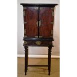 A nineteenth century Celanese small hardwood cabinet, with an ebony cavetto cornice and mouldings,