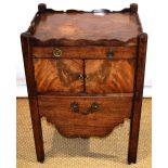 A late eighteenth century mahogany bedside cupboard, the shaped gallery with hand grips above a